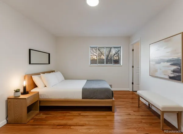 a bedroom with a bed and a couch