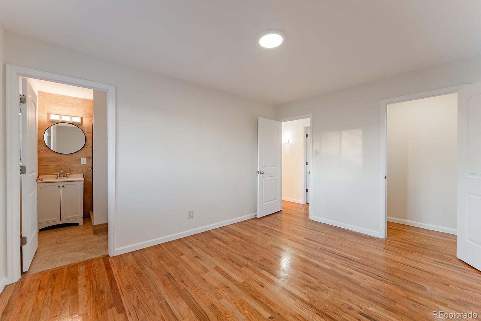 3091 South Yates Street Denver, CO 80236 - Photo 26 of 46 a view of an empty room and wooden floor