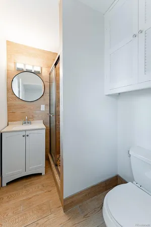 a bathroom with a toilet a sink and mirror