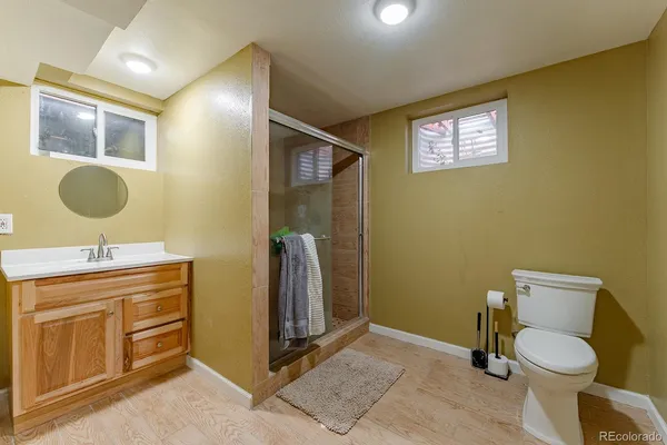 a bathroom with a toilet a sink and mirror