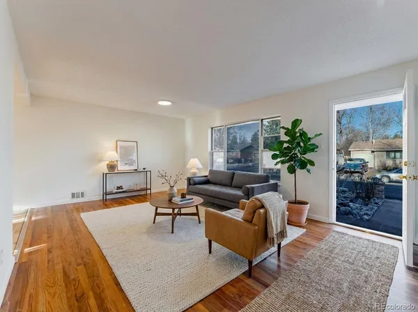 a living room with furniture and a potted plant