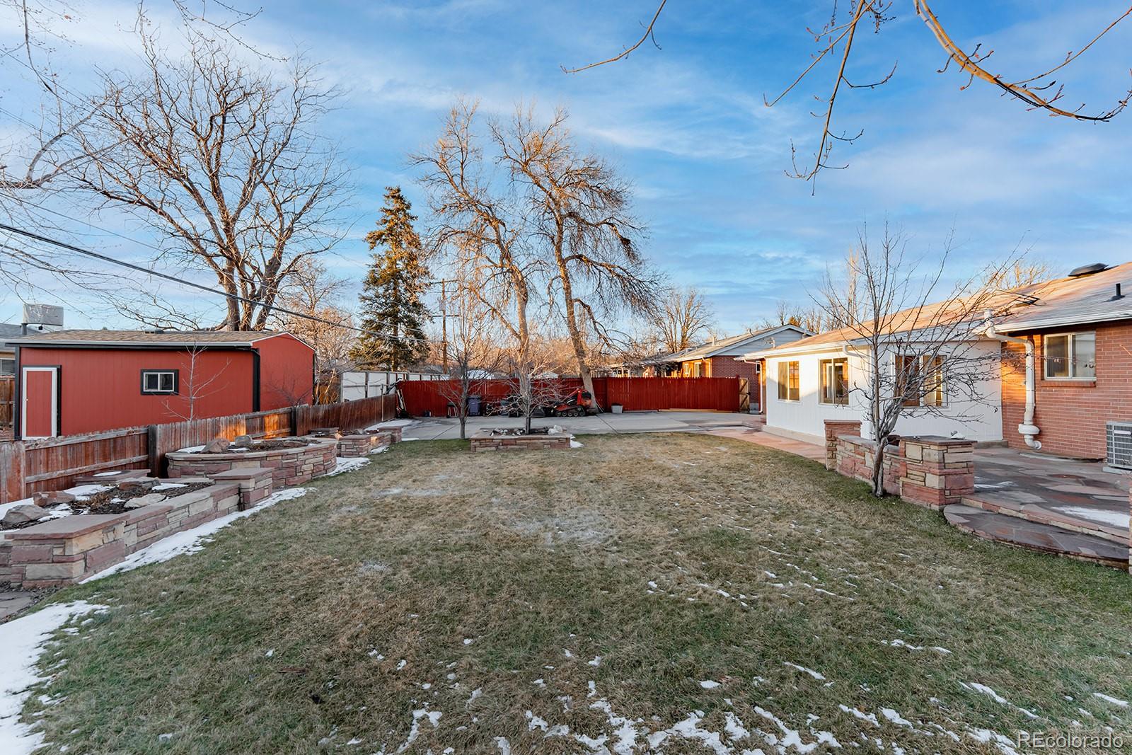 3091 South Yates Street Denver, CO 80236 - Photo 43 of 46 a backyard of a house with fire pit and chairs