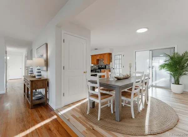 a view of a dining room with furniture and wooden floor