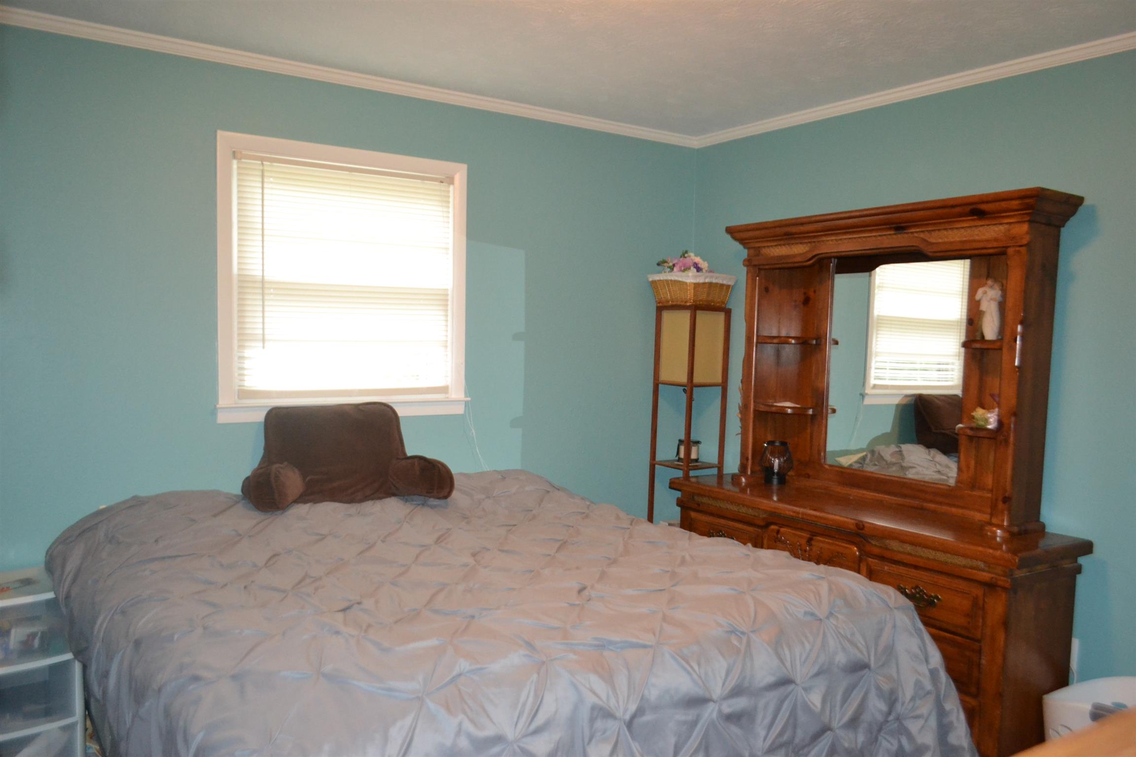 137 Rains Road Morrison, TN 37357 - Photo 12 of 24 a bedroom with a large bed and a potted plant