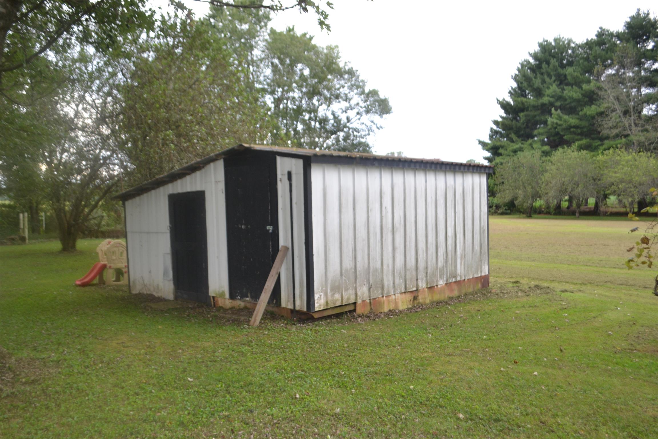 137 Rains Road Morrison, TN 37357 - Photo 5 of 24 a view of a backyard with barn and large trees