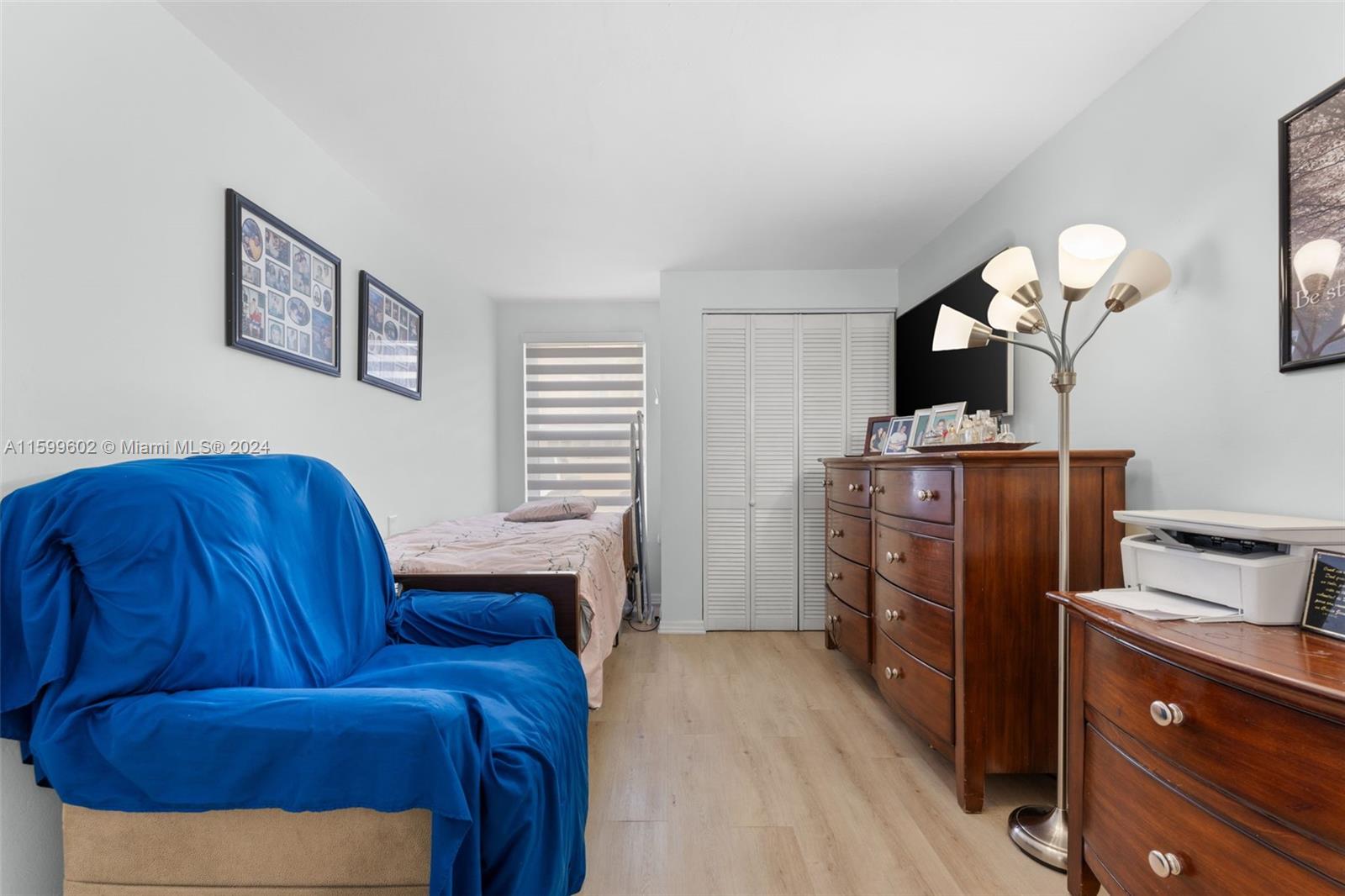 13926 Southwest 65th Terrace, Unit 3 Miami, FL 33183 - Photo 11 of 34 a living room with furniture and a dresser