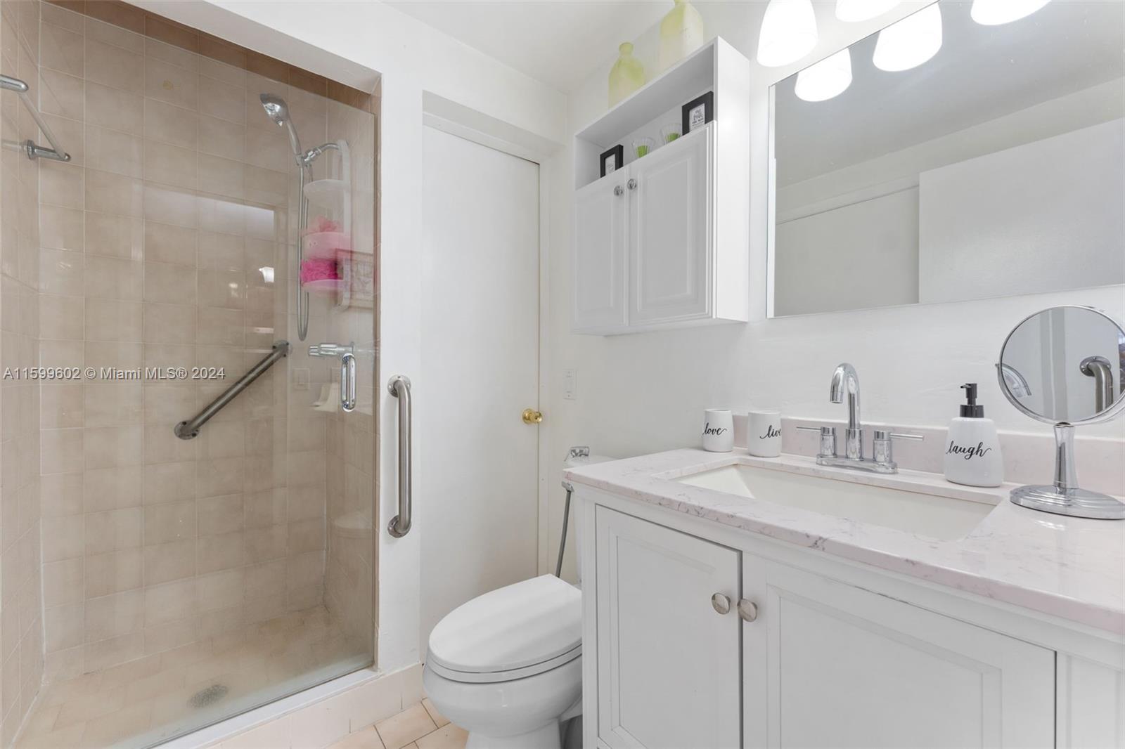 13926 Southwest 65th Terrace, Unit 3 Miami, FL 33183 - Photo 12 of 34 a bathroom with a sink toilet vanity and shower
