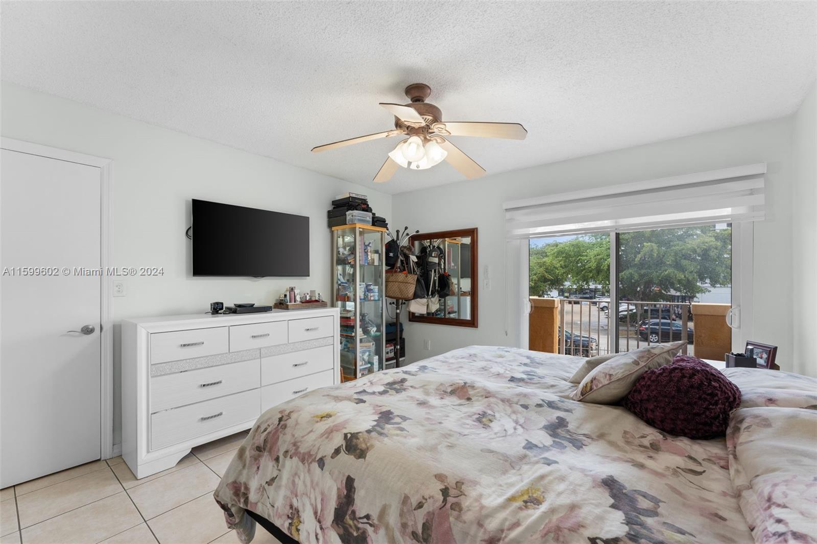 13926 Southwest 65th Terrace, Unit 3 Miami, FL 33183 - Photo 14 of 34 a bedroom with a large bed and a flat tv screen on dresser