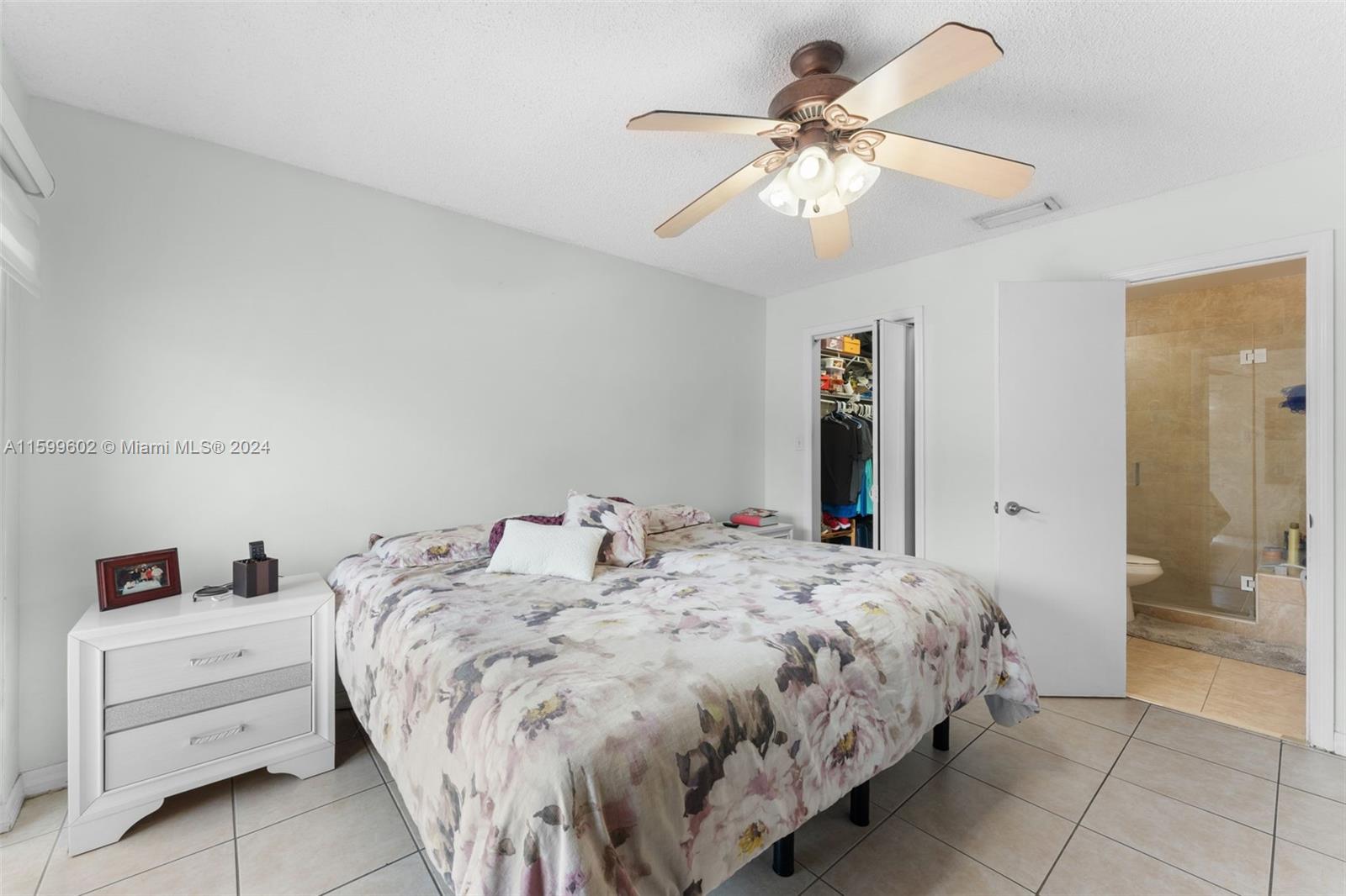 13926 Southwest 65th Terrace, Unit 3 Miami, FL 33183 - Photo 15 of 34 a bedroom with a bed and a chandelier