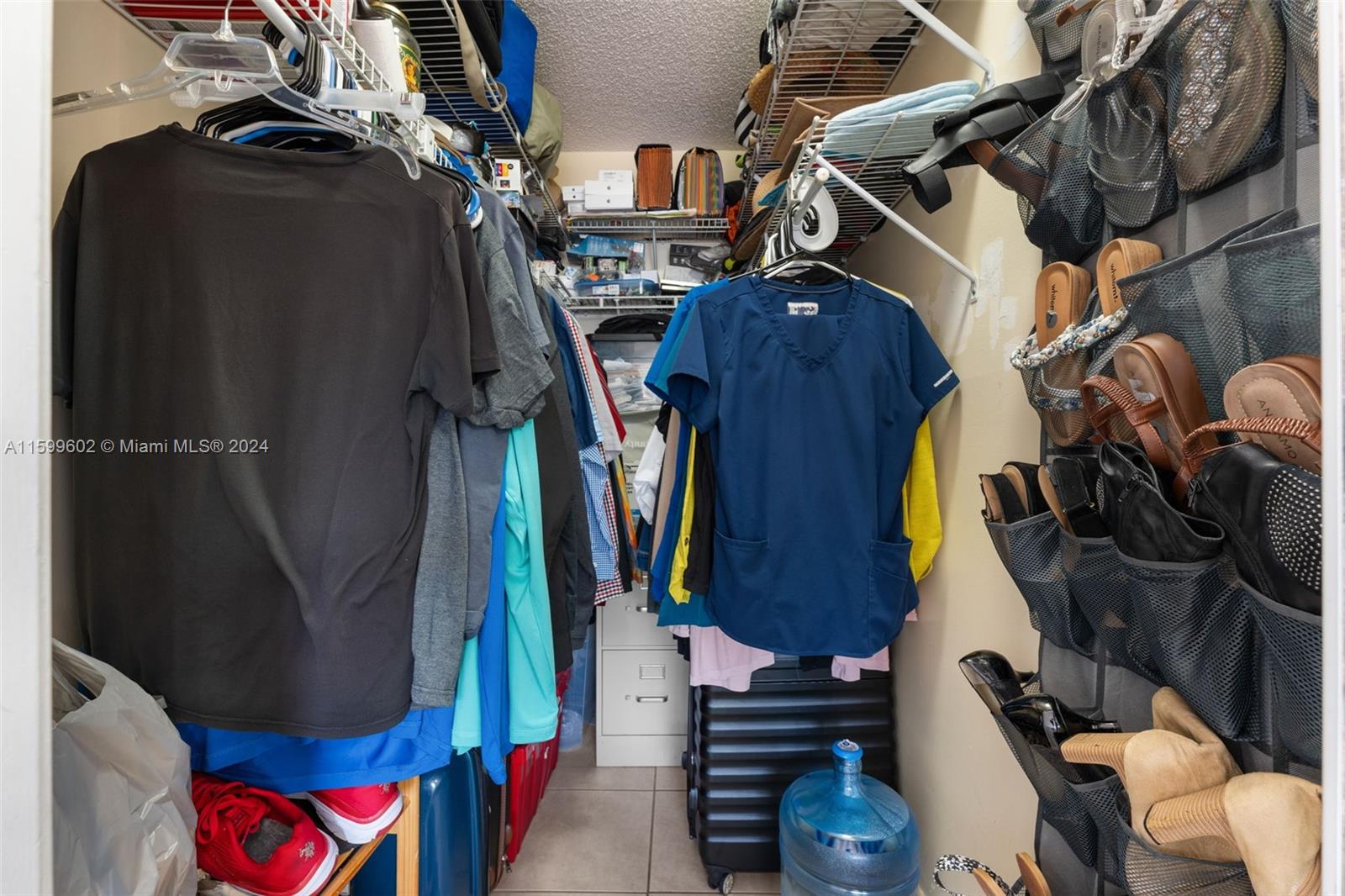 13926 Southwest 65th Terrace, Unit 3 Miami, FL 33183 - Photo 16 of 34 a view of walk in closet with clothes and shoes
