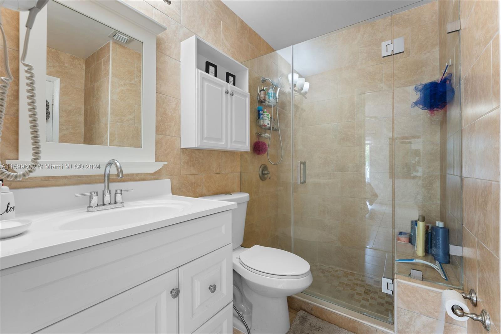 13926 Southwest 65th Terrace, Unit 3 Miami, FL 33183 - Photo 19 of 34 a bathroom with a sink a toilet and shower