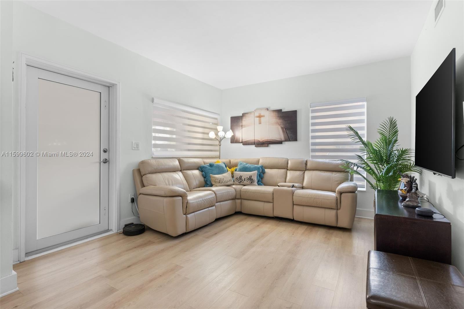 13926 Southwest 65th Terrace, Unit 3 Miami, FL 33183 - Photo 4 of 34 a living room with furniture and a flat screen tv