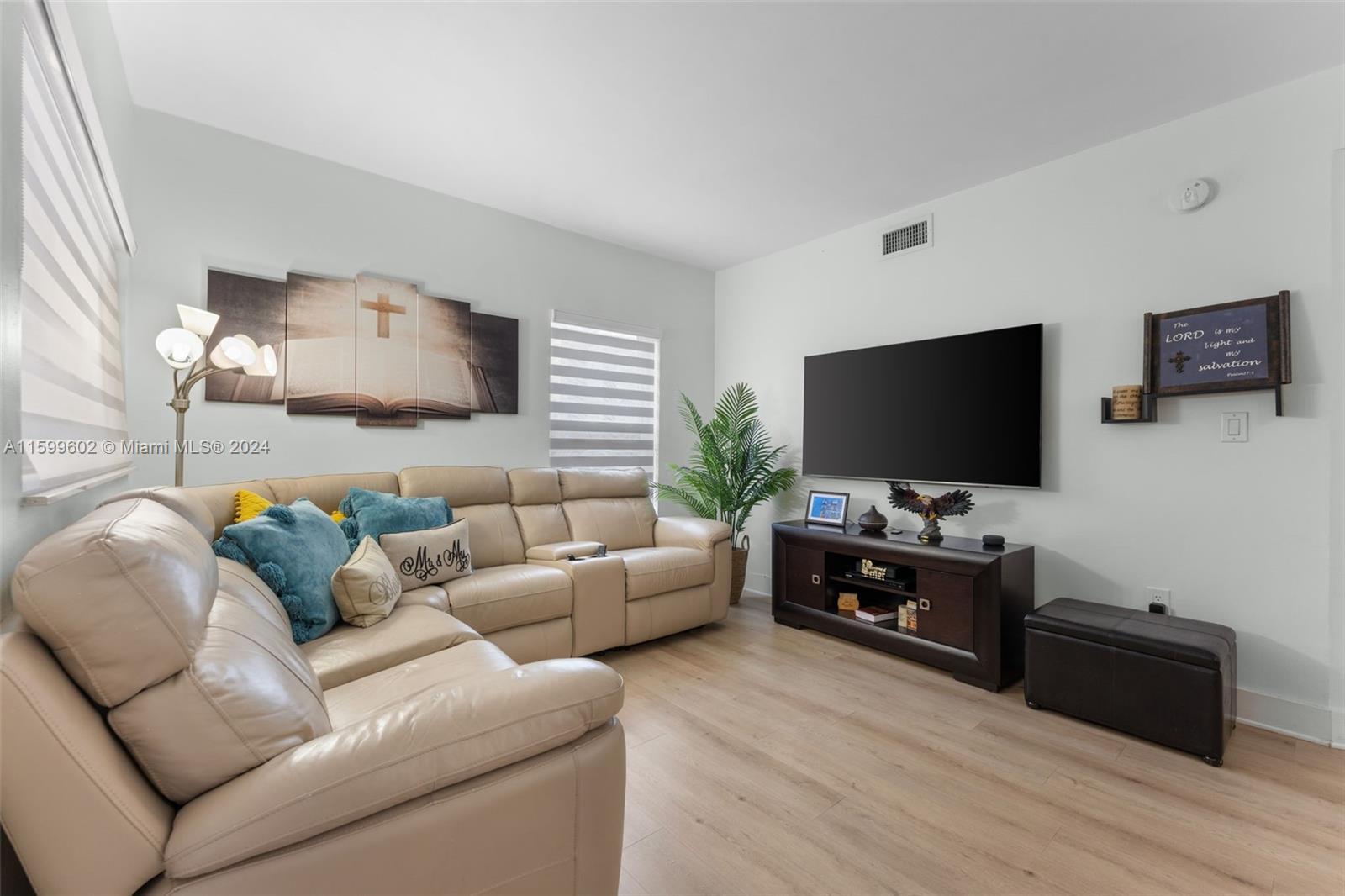 13926 Southwest 65th Terrace, Unit 3 Miami, FL 33183 - Photo 6 of 34 a living room with furniture and a flat screen tv