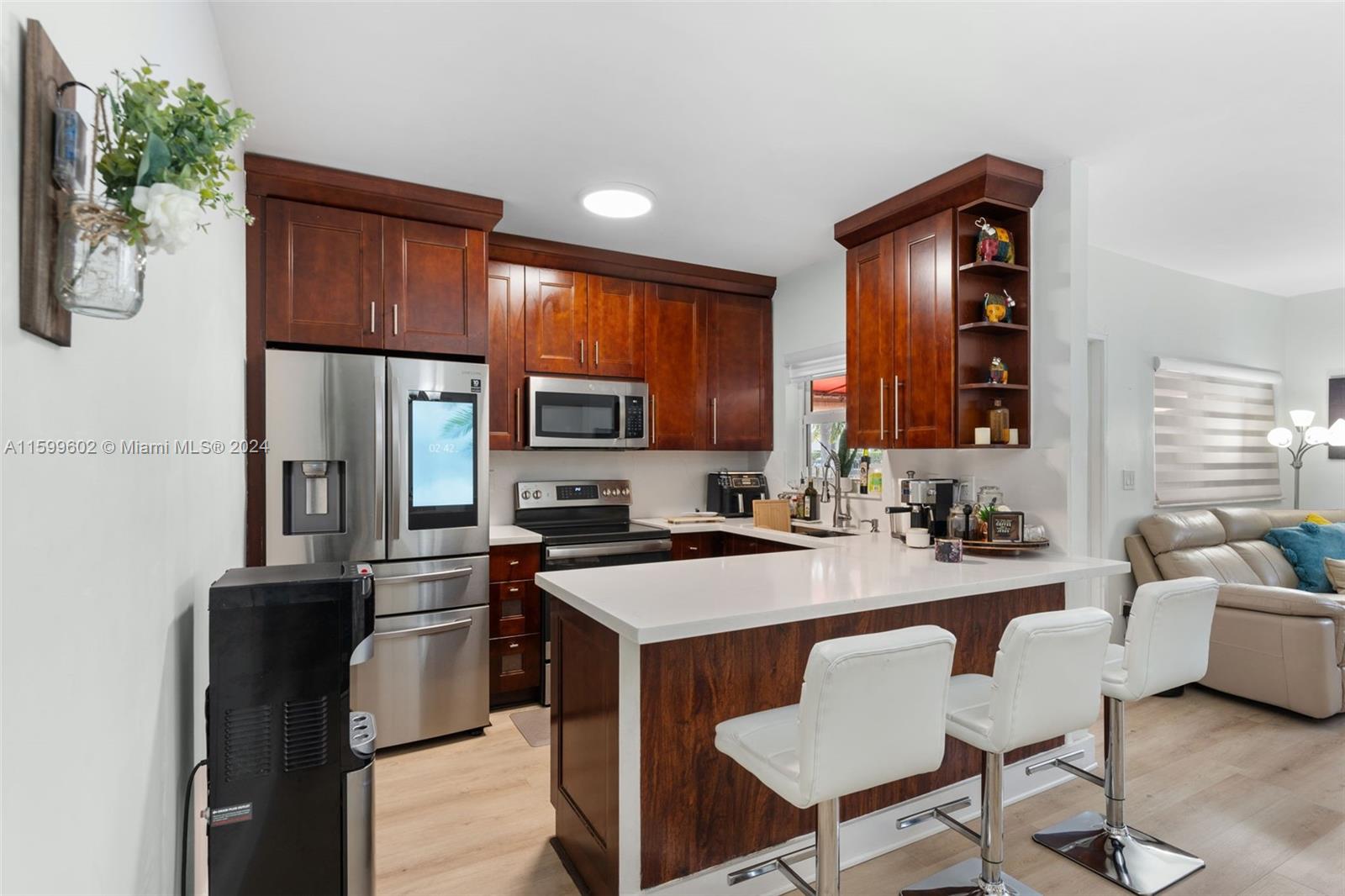 13926 Southwest 65th Terrace, Unit 3 Miami, FL 33183 - Photo 8 of 34 a kitchen with a refrigerator stove and sink