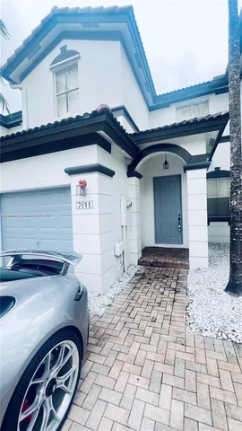 a front view of a house with parking space