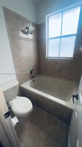 a bathroom with a toilet a sink and bathtub