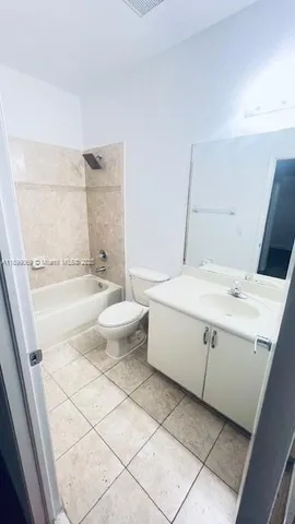 a bathroom with a double vanity sink mirror and toilet