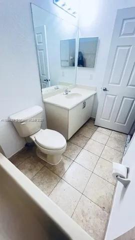 a white toilet sitting next to a bathroom sink