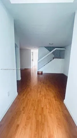 a view of an empty room with stairs