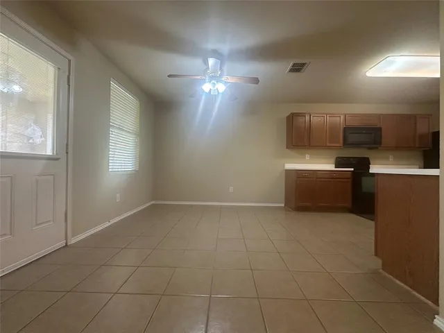 a view of a kitchen with a sink and a refrigerator