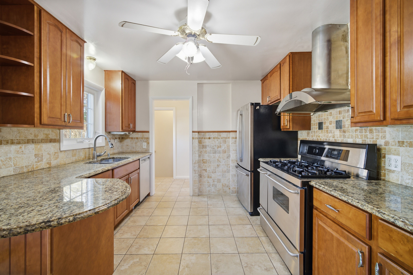1700 Marguerite Street Park Ridge, IL 60068 - Photo 11 of 44 a kitchen with stainless steel appliances granite countertop a sink stove and refrigerator