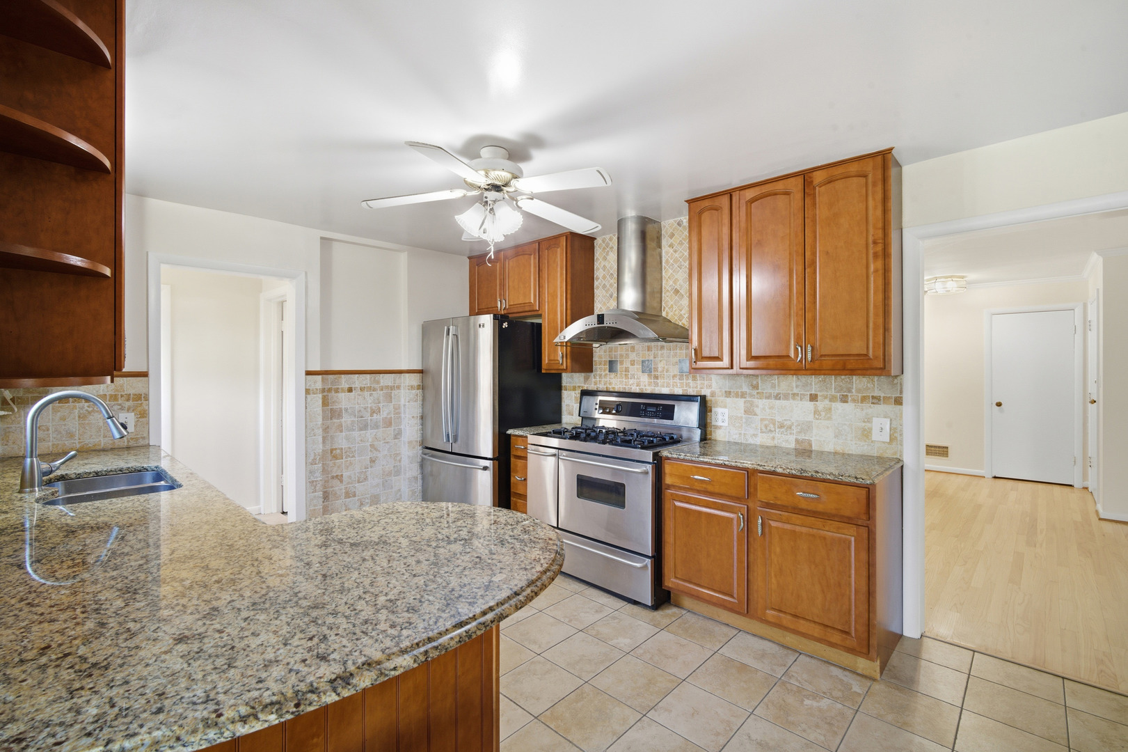 1700 Marguerite Street Park Ridge, IL 60068 - Photo 12 of 44 a kitchen with stainless steel appliances granite countertop a sink stove and refrigerator