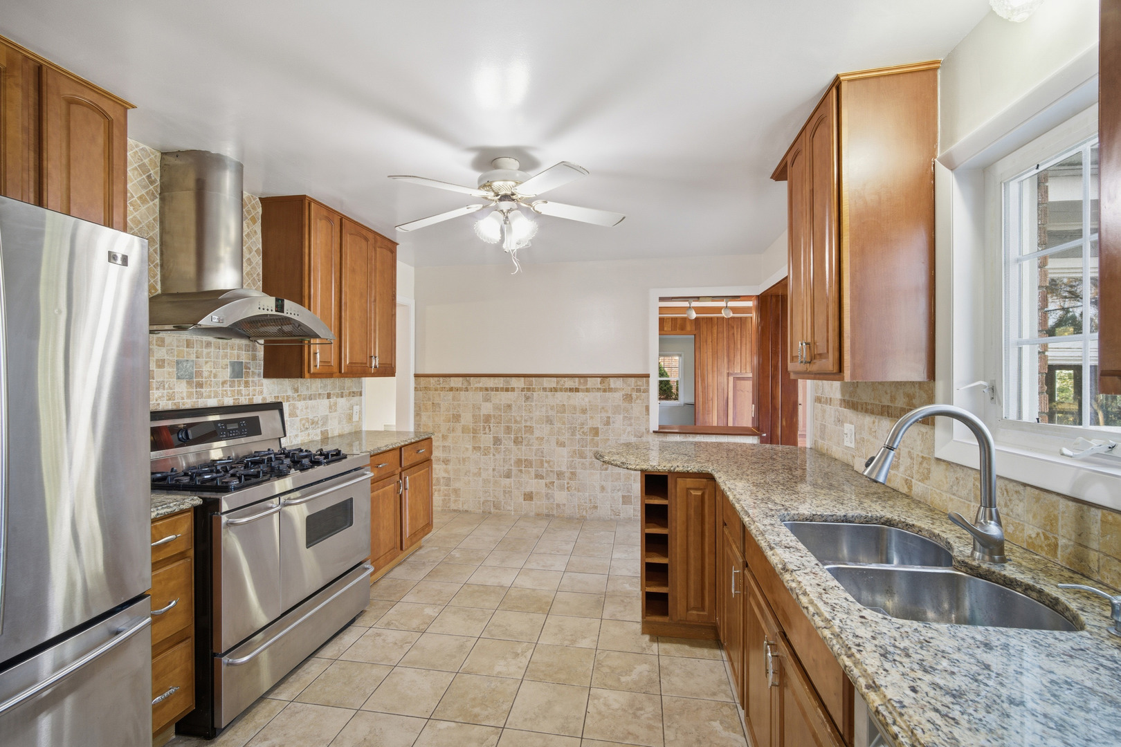 1700 Marguerite Street Park Ridge, IL 60068 - Photo 13 of 44 a kitchen with stainless steel appliances granite countertop a sink stove and refrigerator