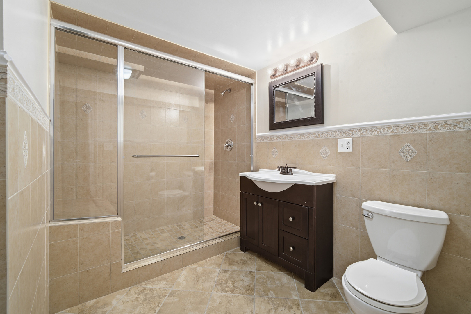 1700 Marguerite Street Park Ridge, IL 60068 - Photo 30 of 44 a bathroom with a toilet sink vanity and shower