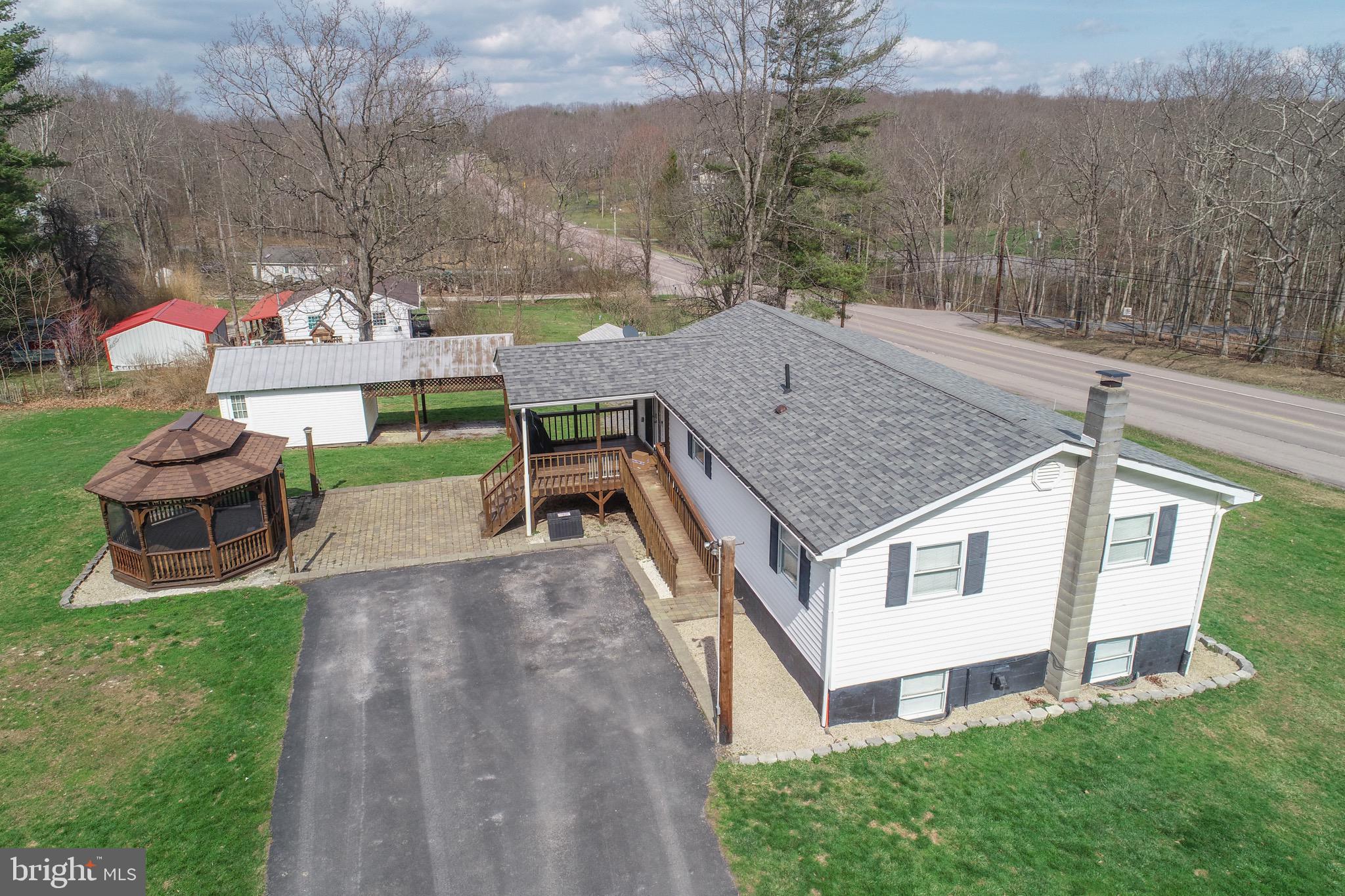 18 Ollie North Road Oakland, MD 21550 - Photo 2 of 48 a view of a white house with a yard and furniture