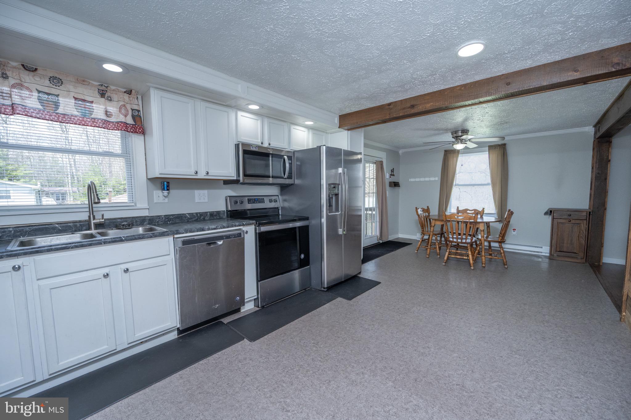 18 Ollie North Road Oakland, MD 21550 - Photo 3 of 48 a kitchen with stainless steel appliances kitchen island granite countertop a sink cabinets and counter space