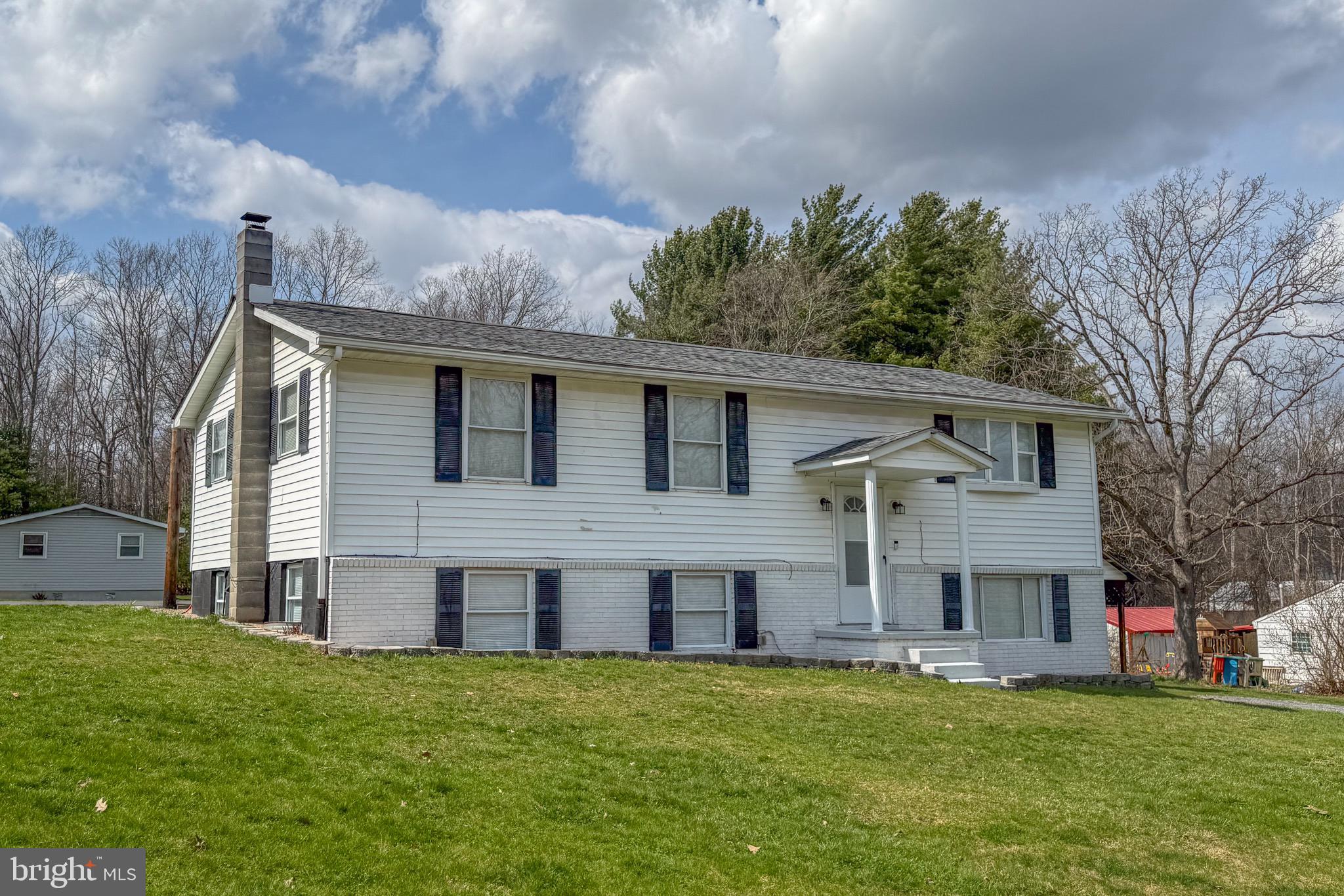 18 Ollie North Road Oakland, MD 21550 - Photo 43 of 48 a front view of house with yard and trees in the background
