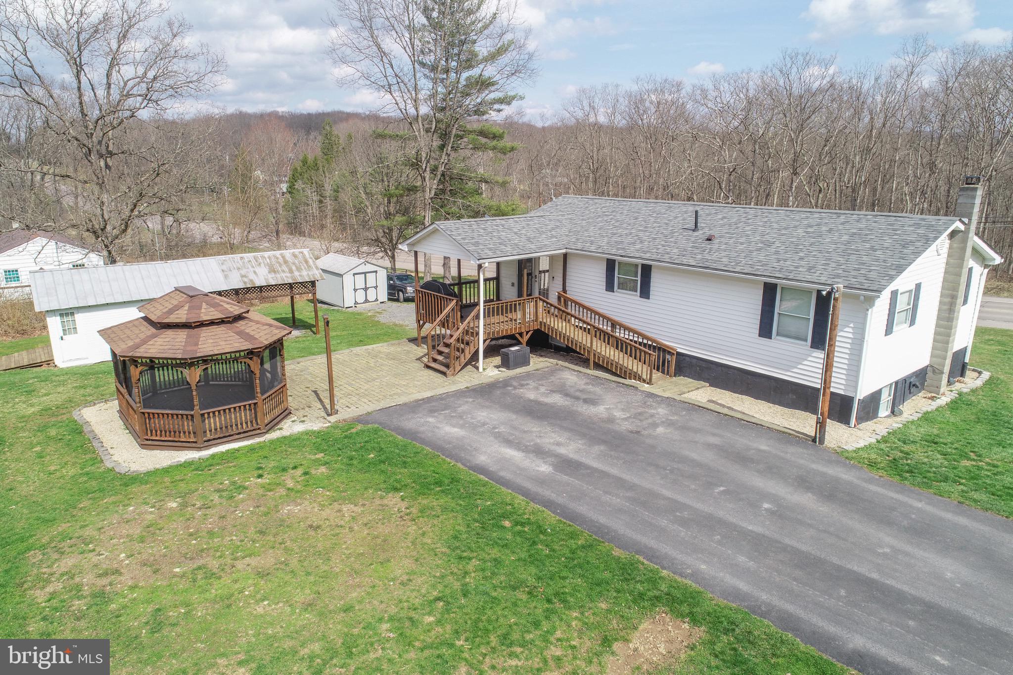 18 Ollie North Road Oakland, MD 21550 - Photo 48 of 48 a view of a house with a yard and sitting area