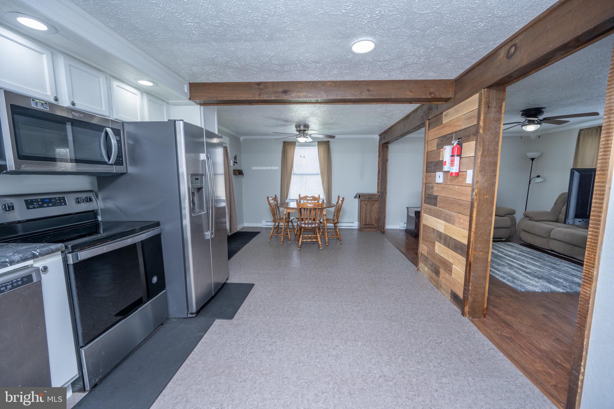 18 Ollie North Road Oakland, MD 21550 - Photo 6 of 48 a living room with stainless steel appliances furniture a fireplace a flat screen tv and a sink