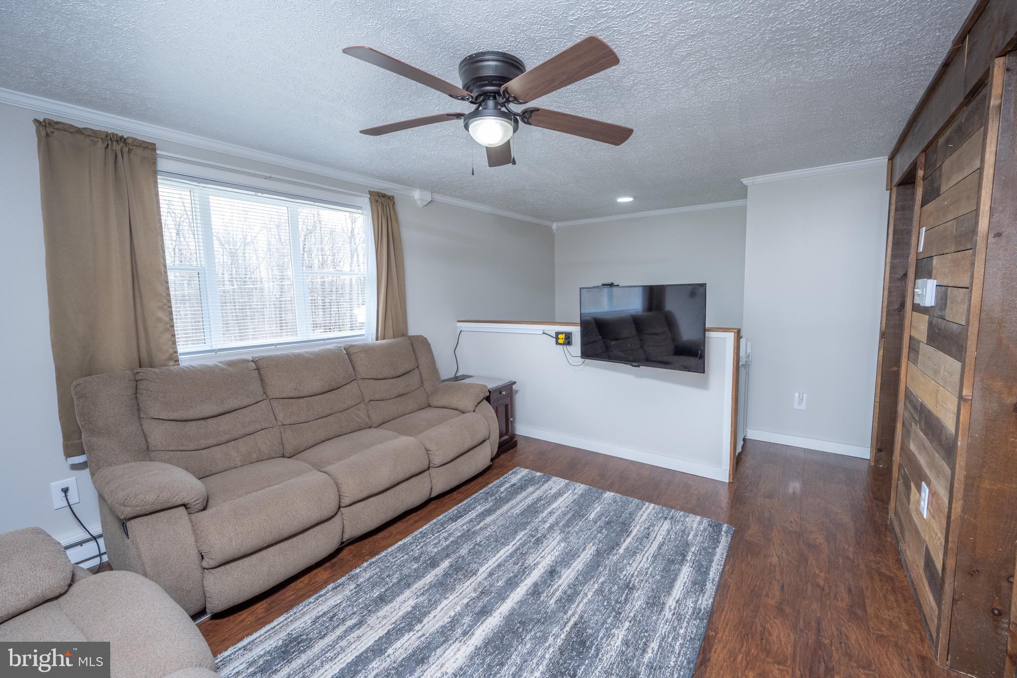 18 Ollie North Road Oakland, MD 21550 - Photo 9 of 48 a living room with furniture and a flat screen tv