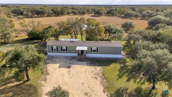an aerial view of a house with a yard