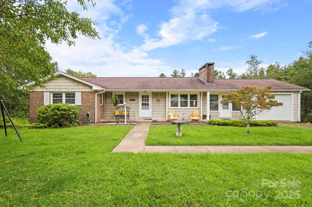 a front view of a house with a yard and porch