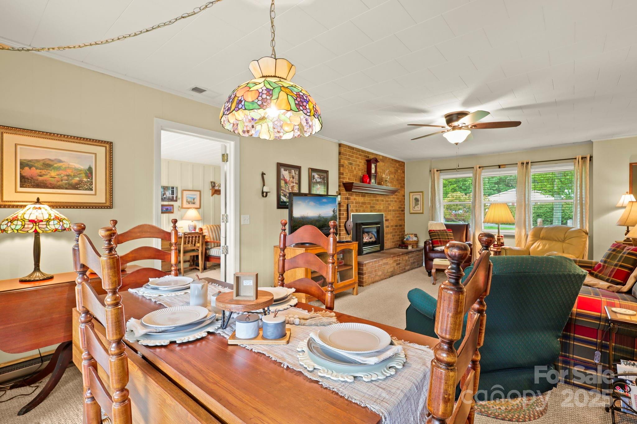 1074 Nikanor Road West Jefferson, NC 28694 - Photo 11 of 45 a view of a dining room with furniture a chandelier and large windows