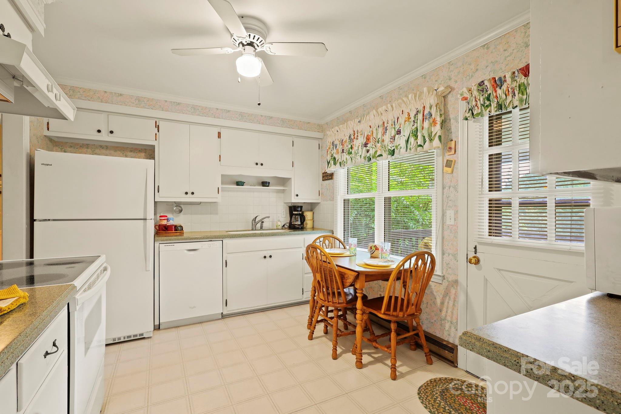 1074 Nikanor Road West Jefferson, NC 28694 - Photo 12 of 45 a dining room with furniture a kitchen a chandelier and wooden floor