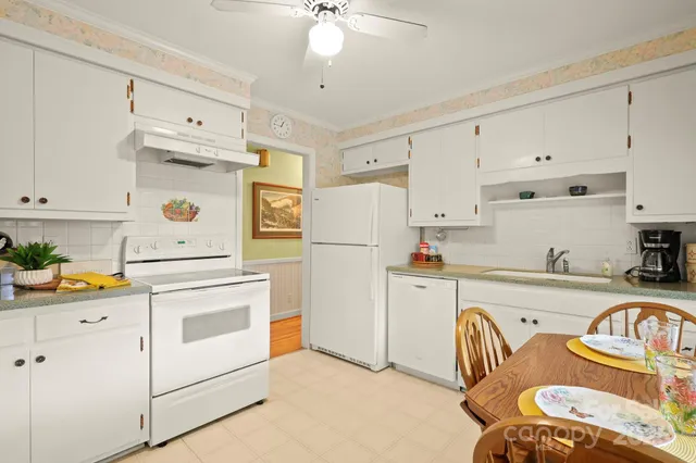 a kitchen with stainless steel appliances a refrigerator sink and cabinets