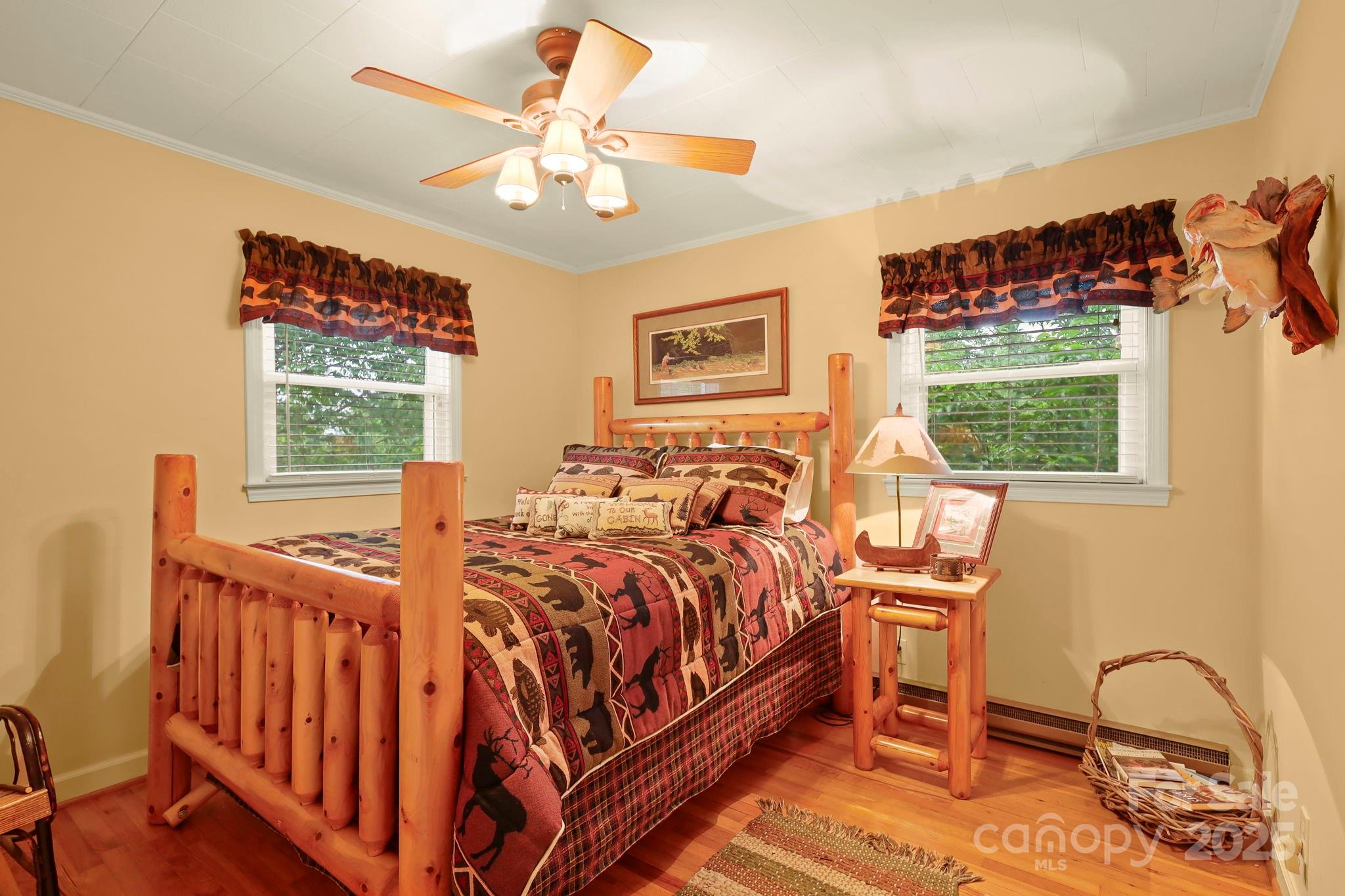 1074 Nikanor Road West Jefferson, NC 28694 - Photo 18 of 45 a bedroom with a bed next to a window with a chandelier