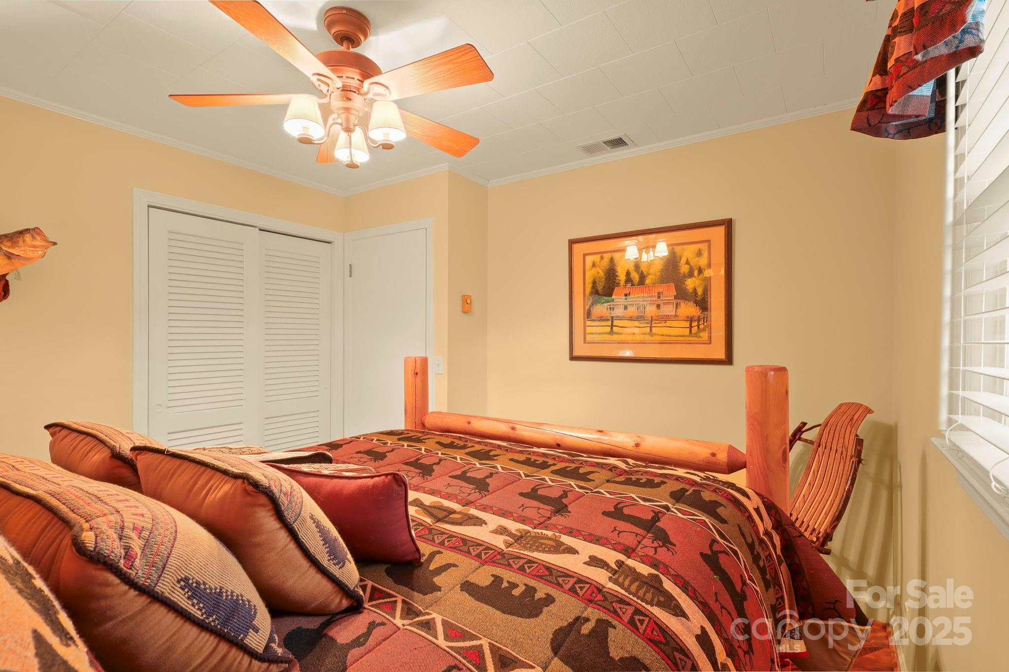 1074 Nikanor Road West Jefferson, NC 28694 - Photo 19 of 45 a bedroom with a bed and a chandelier