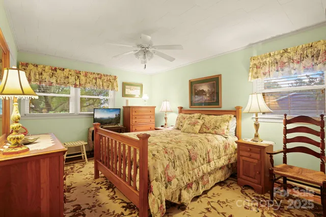 a bedroom with 2 bed and a window