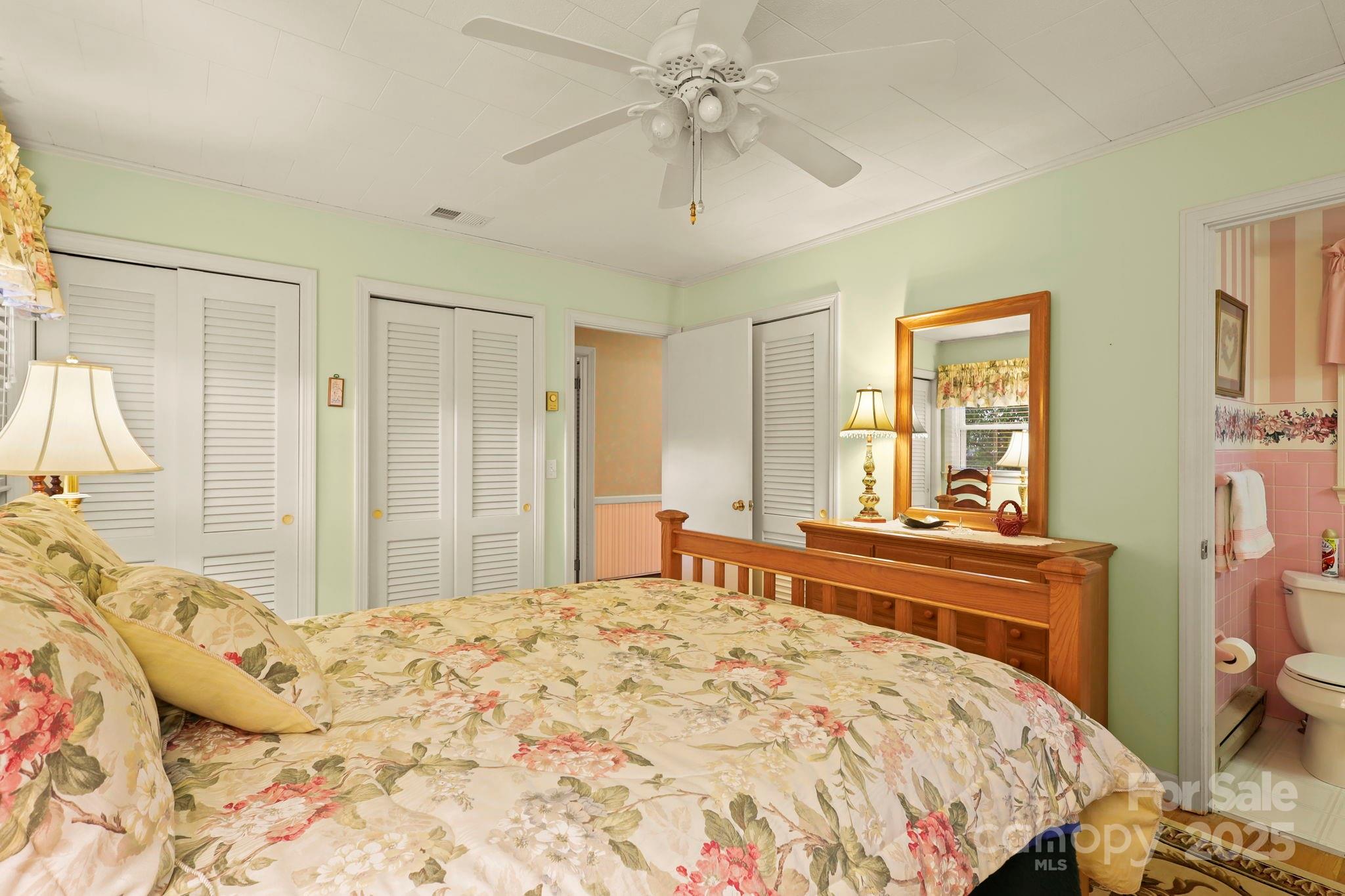 1074 Nikanor Road West Jefferson, NC 28694 - Photo 21 of 45 a bedroom with a bed and a chandelier