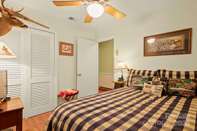 a bedroom with a bed and a chandelier