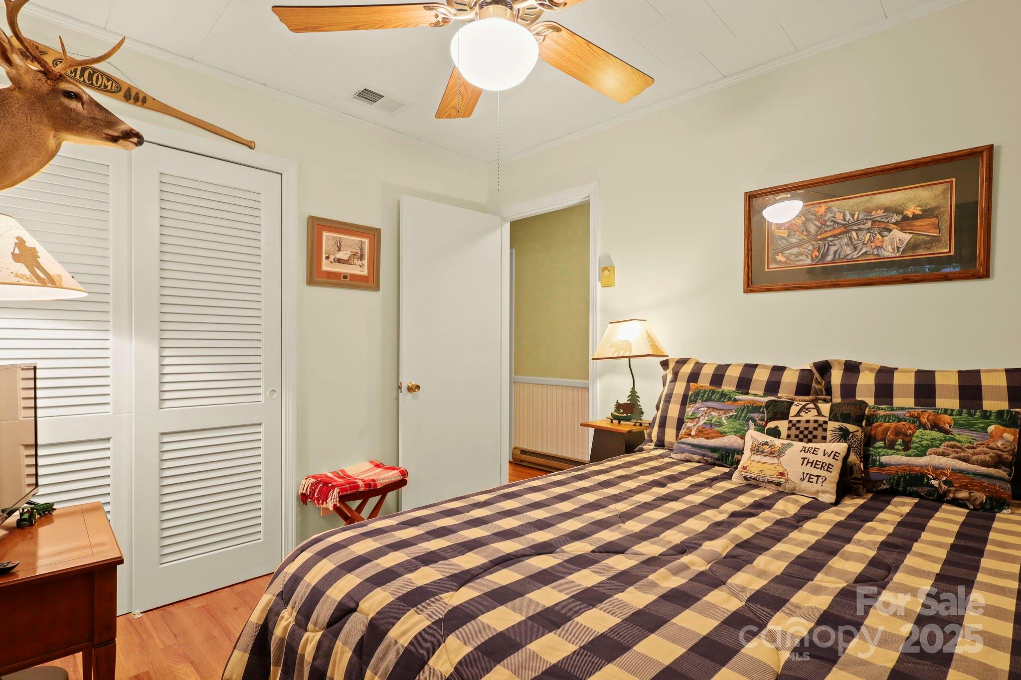 1074 Nikanor Road West Jefferson, NC 28694 - Photo 25 of 45 a bedroom with a bed and a chandelier