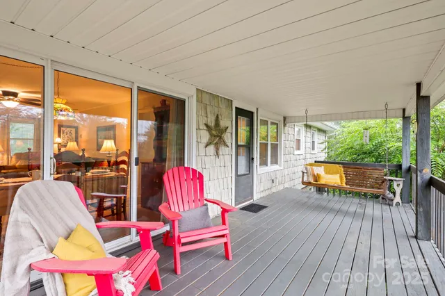 a balcony with furniture and wooden floor