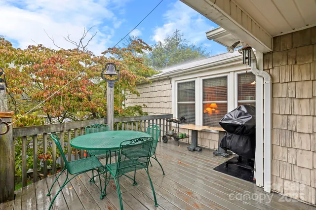 a backyard of a house with table and chairs