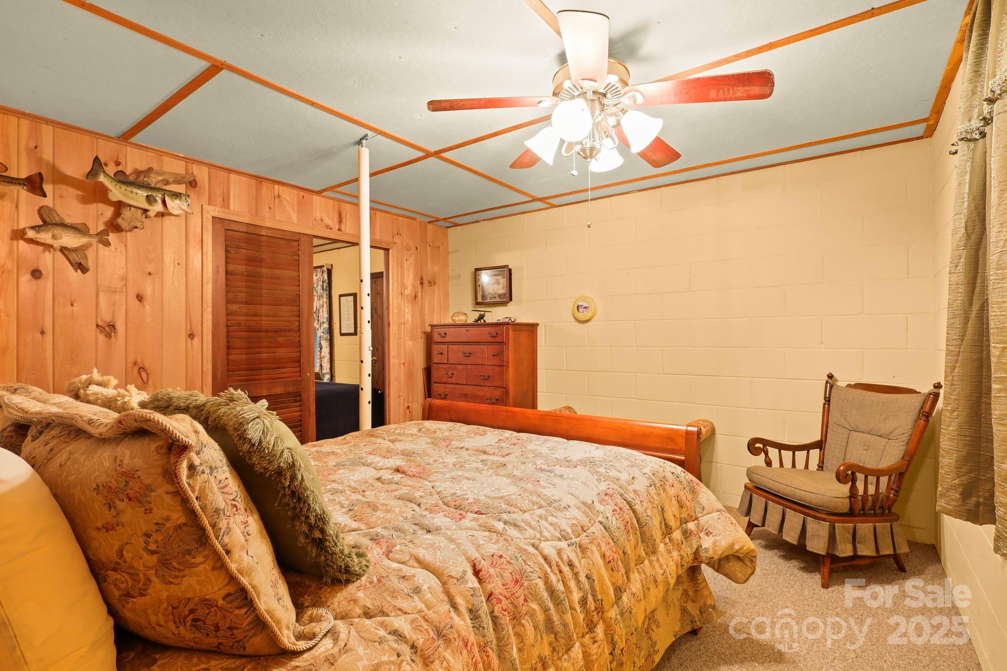 1074 Nikanor Road West Jefferson, NC 28694 - Photo 33 of 45 a bedroom with a bed and chair