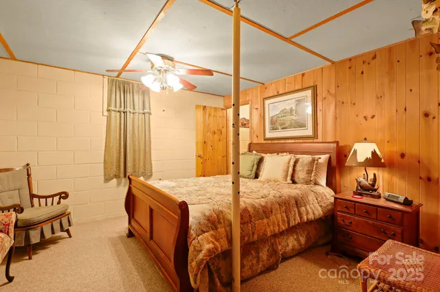 a bedroom with a bed a couch and dresser