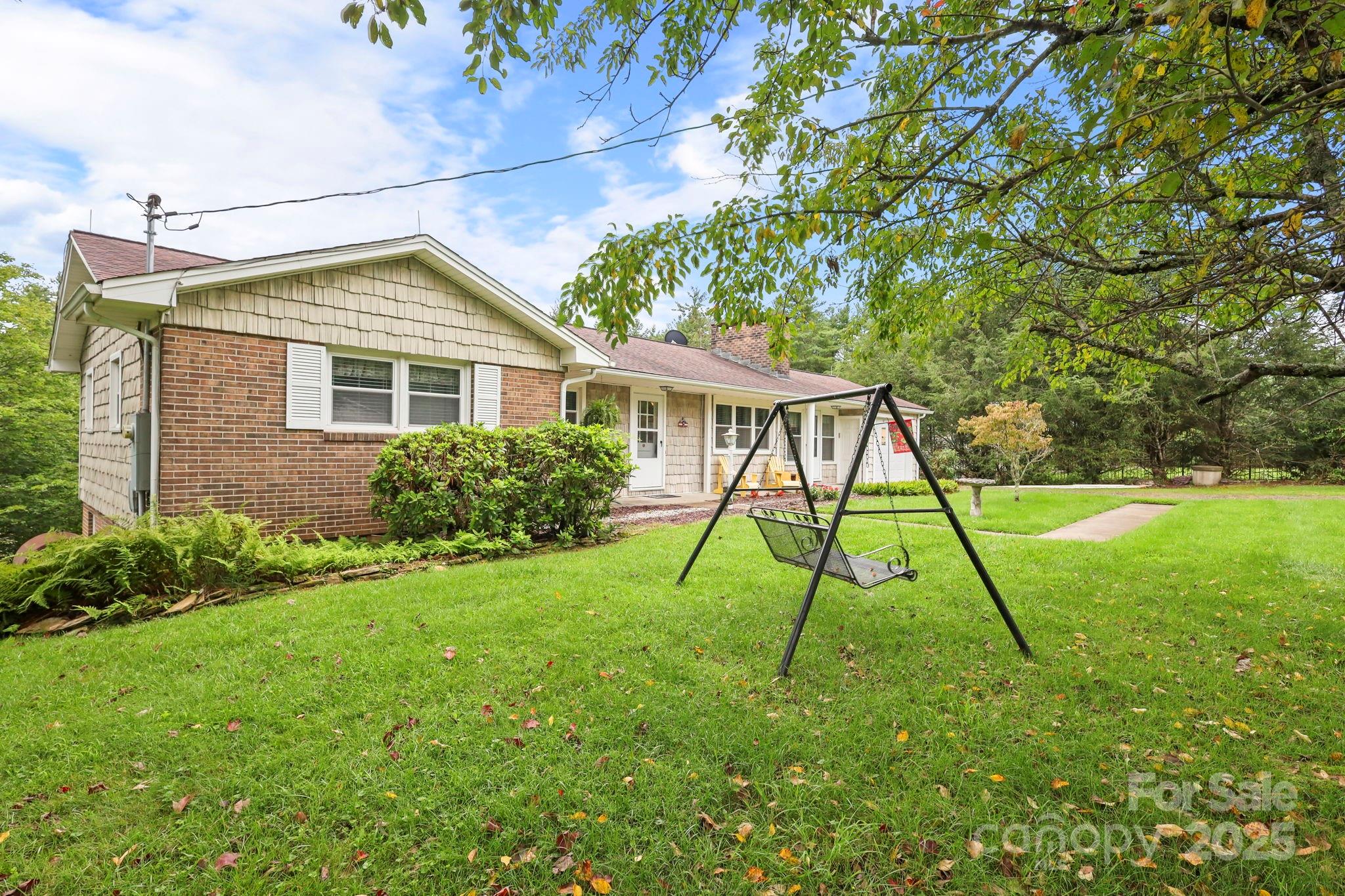 1074 Nikanor Road West Jefferson, NC 28694 - Photo 4 of 45 a view of a house with a backyard